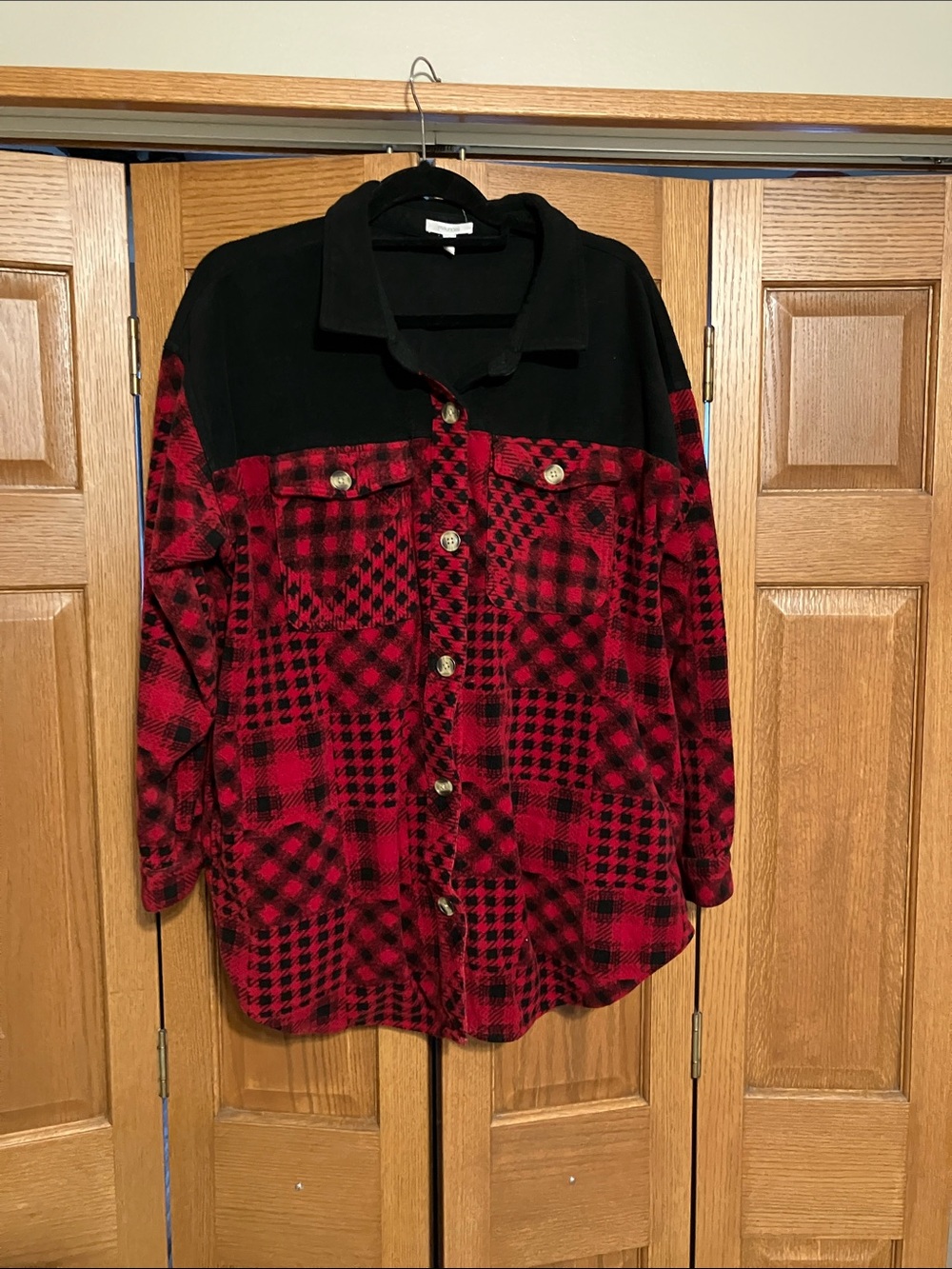 This is a Maurices patchwork fleece shacket in a red and black plaid pattern.